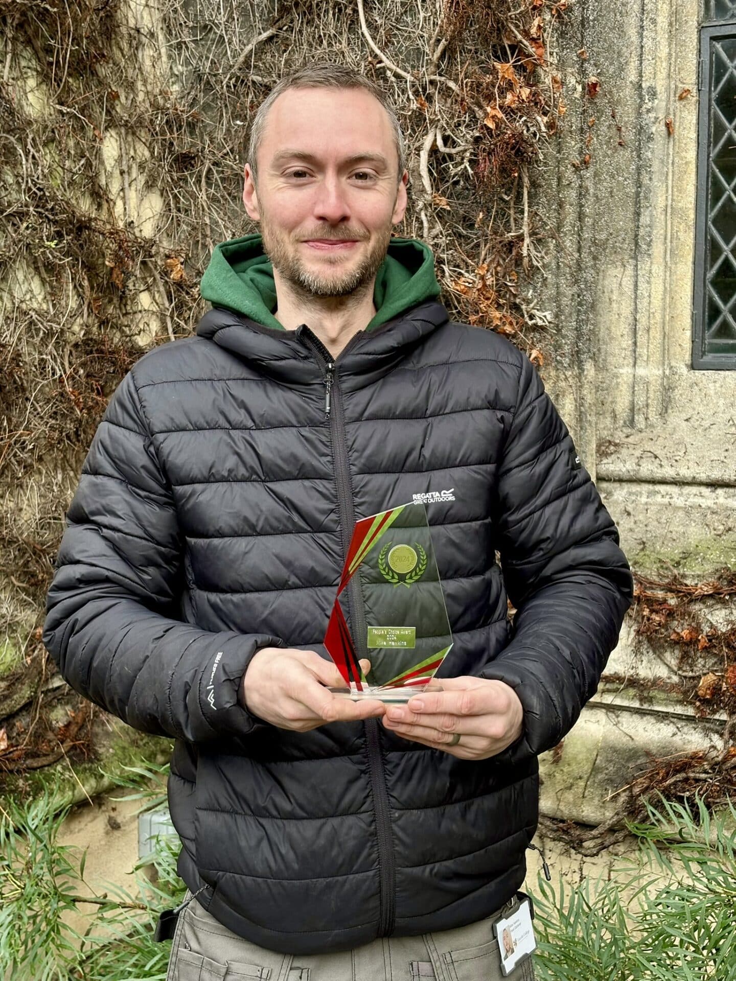 Mike Hawkins holding award
