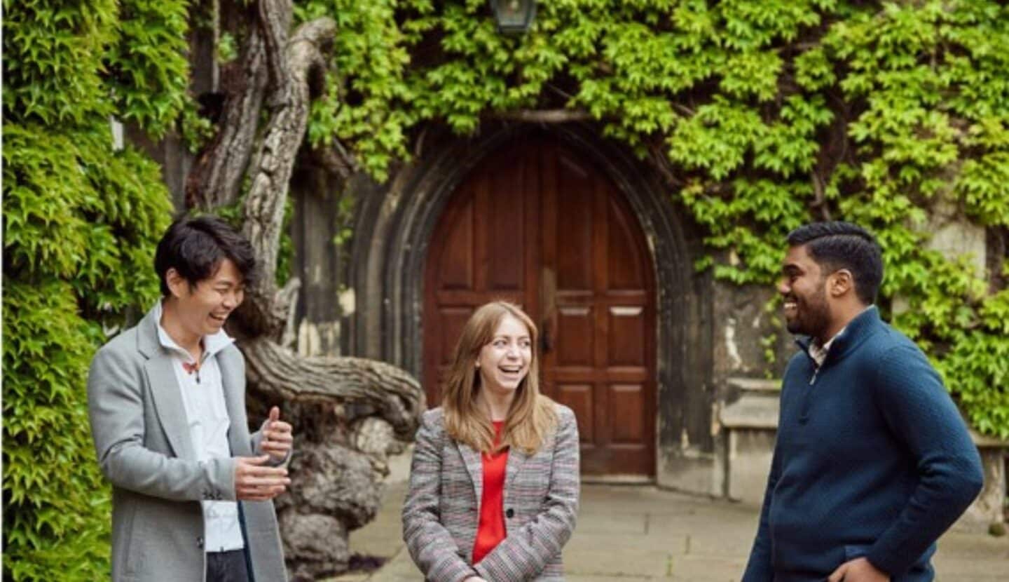 Three students talking in Lincoln front quad