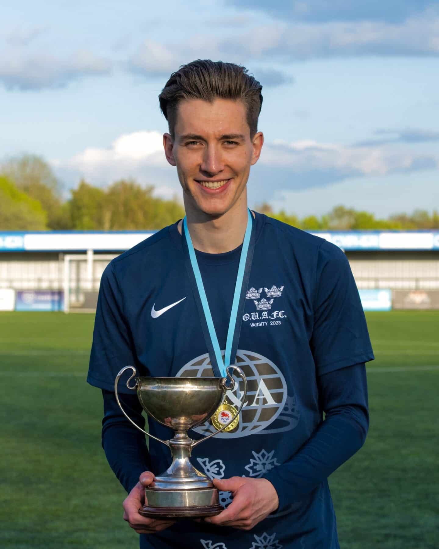 Fidan Suljik waring Blues football kit and holding trophy