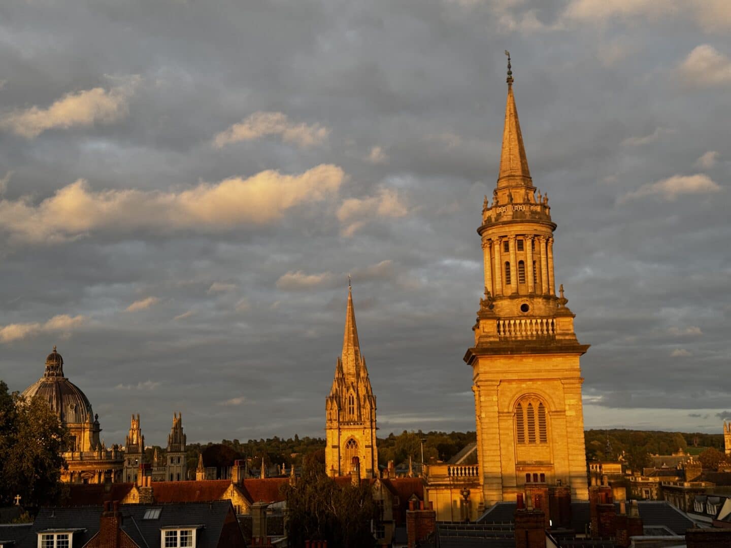 The Library tower illuminated in golden evening light, with Oxford’s Radcliffe Camera and University Church spire visible in the background.