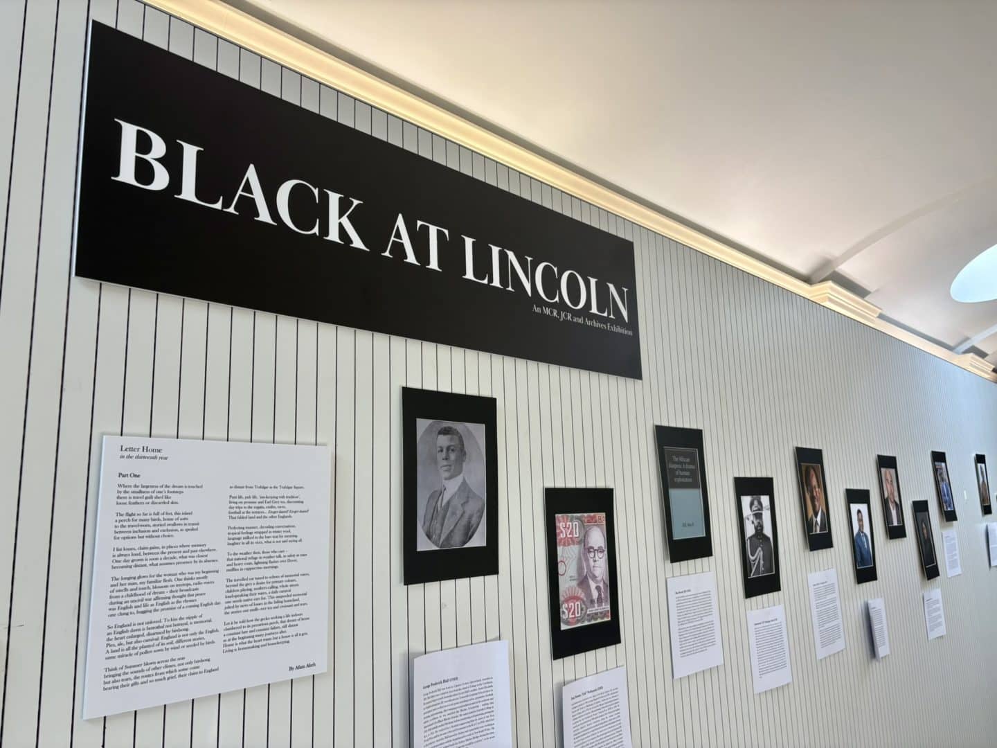 Wide view of the Black at Lincoln exhibition in the Berrow Foundation Building, with a large black title panel above a long display of portraits, archival images and accompanying interpretation panels.