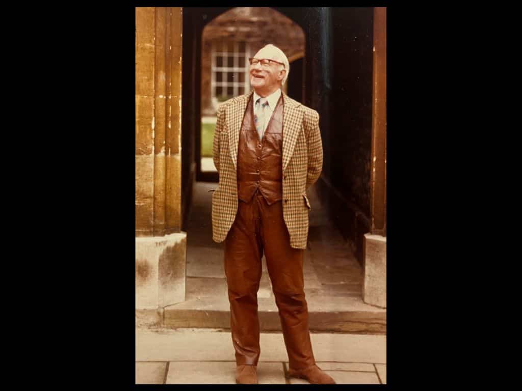 Portrait photograph of Vivian H. H. Green, Fellow and later Rector of Lincoln College, standing in college wearing a checked jacket and brown leather waistcoat and trousers.