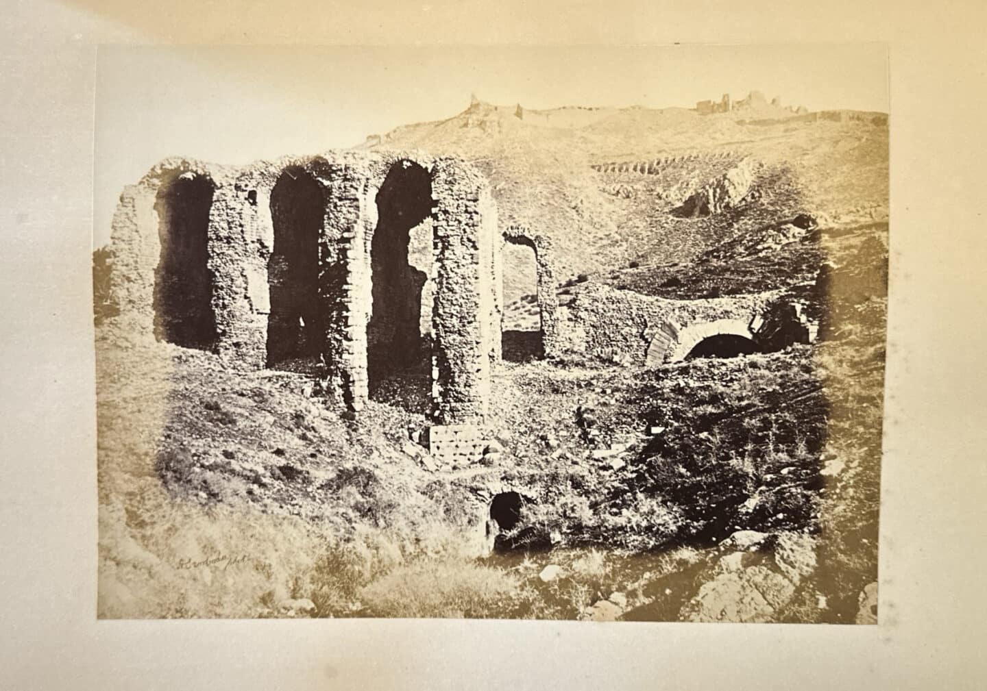 Image shown is of a black and white photograph depicting the ruins of Pergamos (formerly in the Ottoman Empire). Photo taken in 1869.