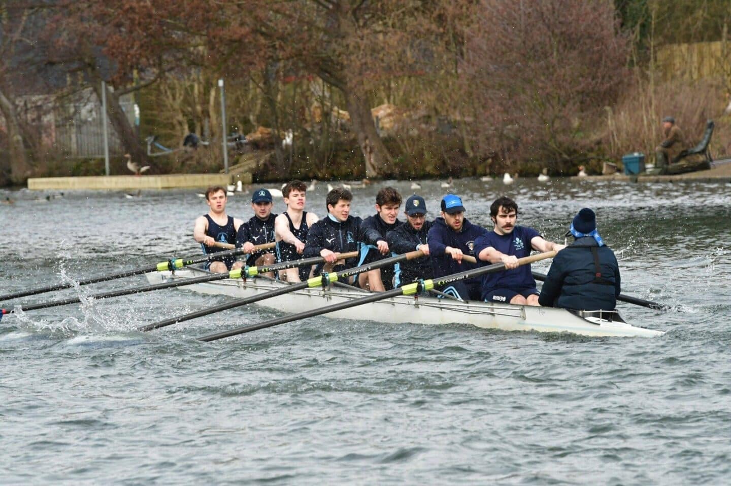 Crew of Lincoln students rowing on the river.