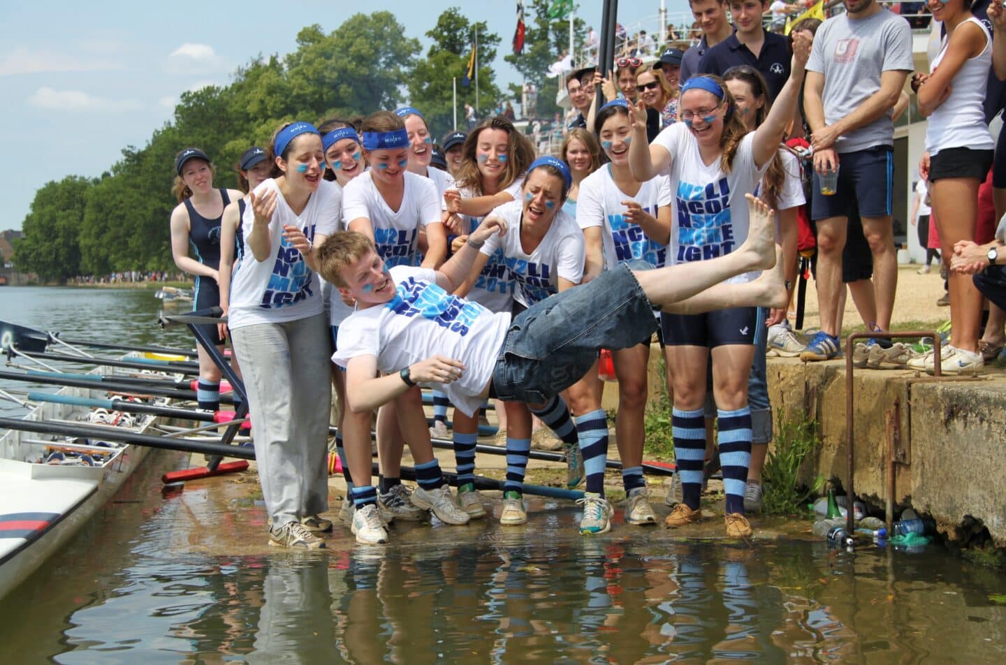 W2 throwing in their Cox at Summer VIIIs, 2011: Lincoln College Women's Second VIII celebrate by throwing their cox into the river after Summer Eights 2011.