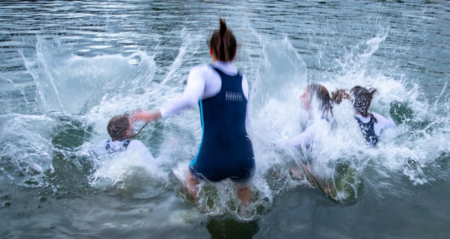 Women's First VIII celebrating winning blades, 2023: Lincoln College Women's First VIII celebrate winning blades by jumping into the River Thames after Summer Eights 2023