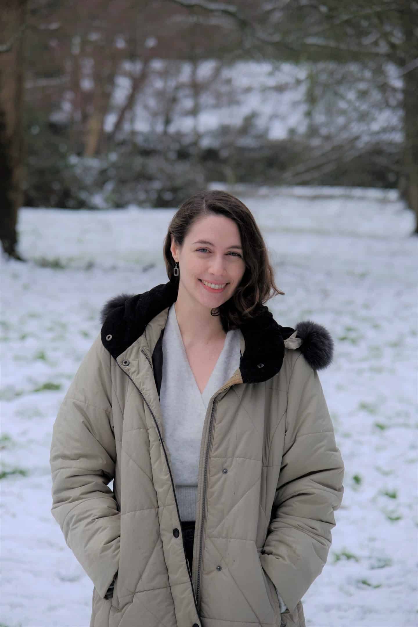 Photograph of Angeliki Brazeau, a woman wearing a long coat, against a snowy background