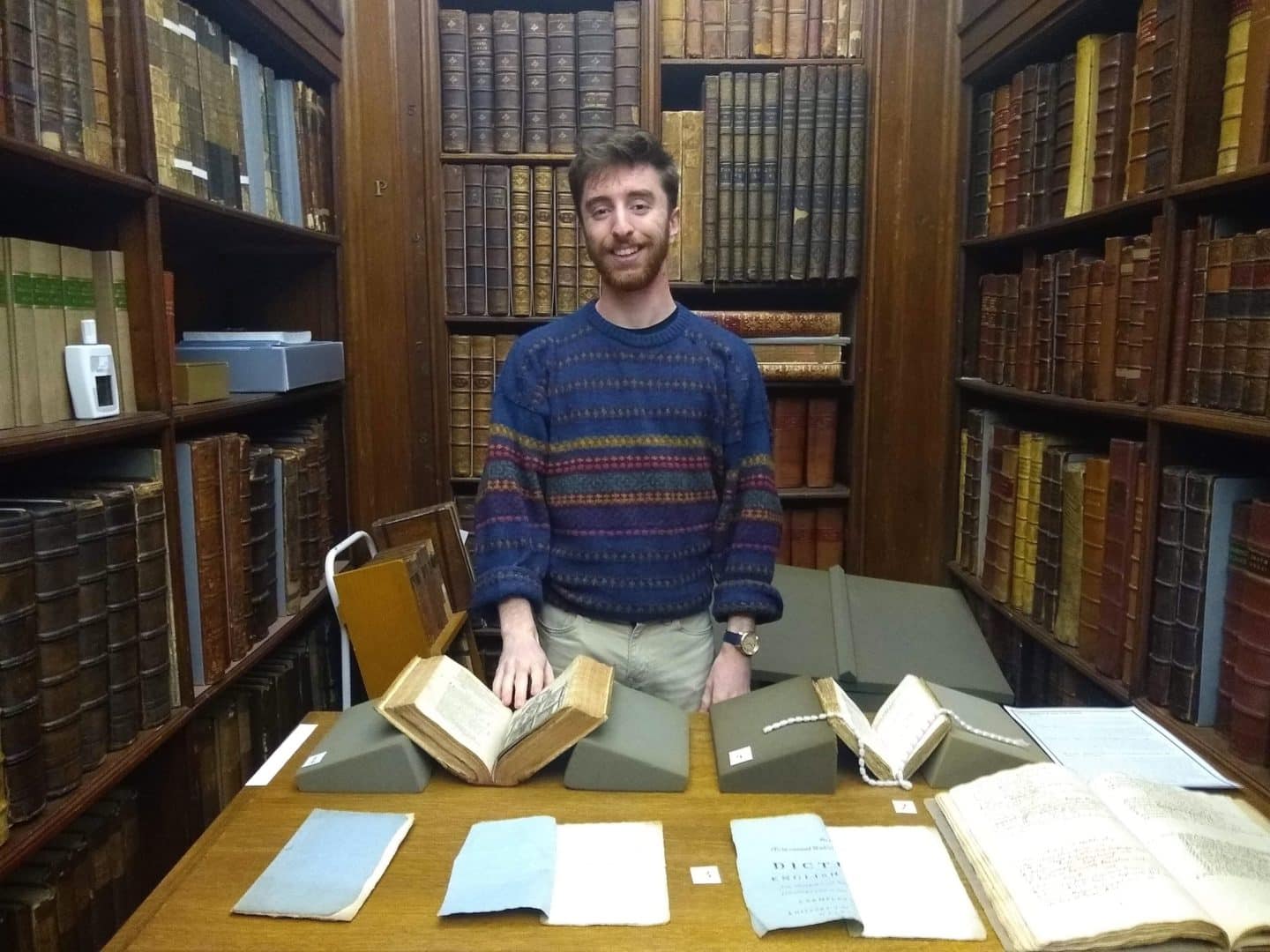 Ben Barrett pictured with his exhibition at an Unlocking the Senior Library event