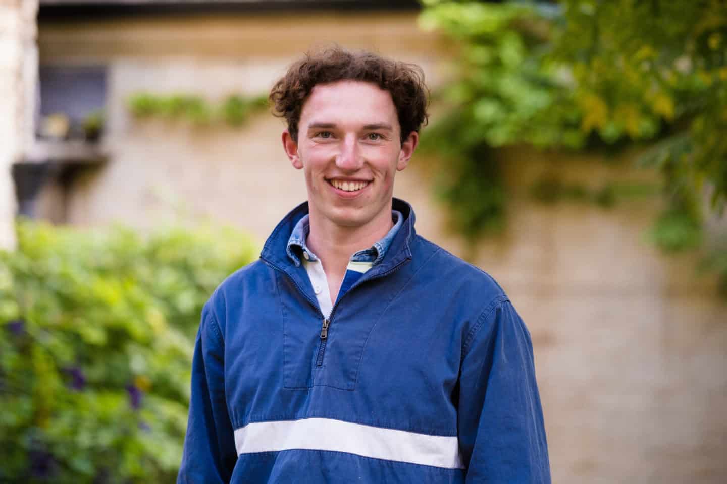 Headshot of Ben Coady, a man in a blue jacket