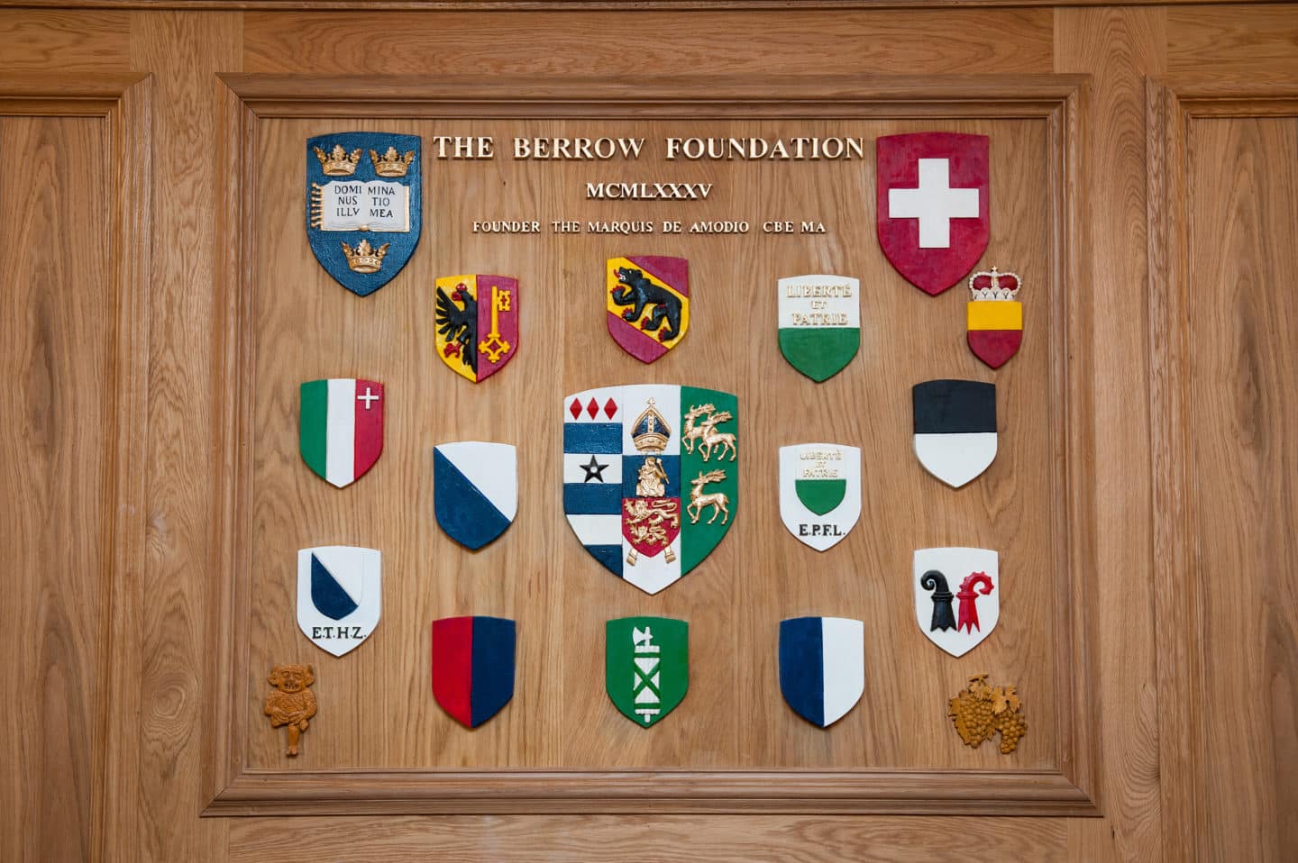A plaque in the Berrow Foundation Building, with the crests of Lincoln College and cantons of Switzerland