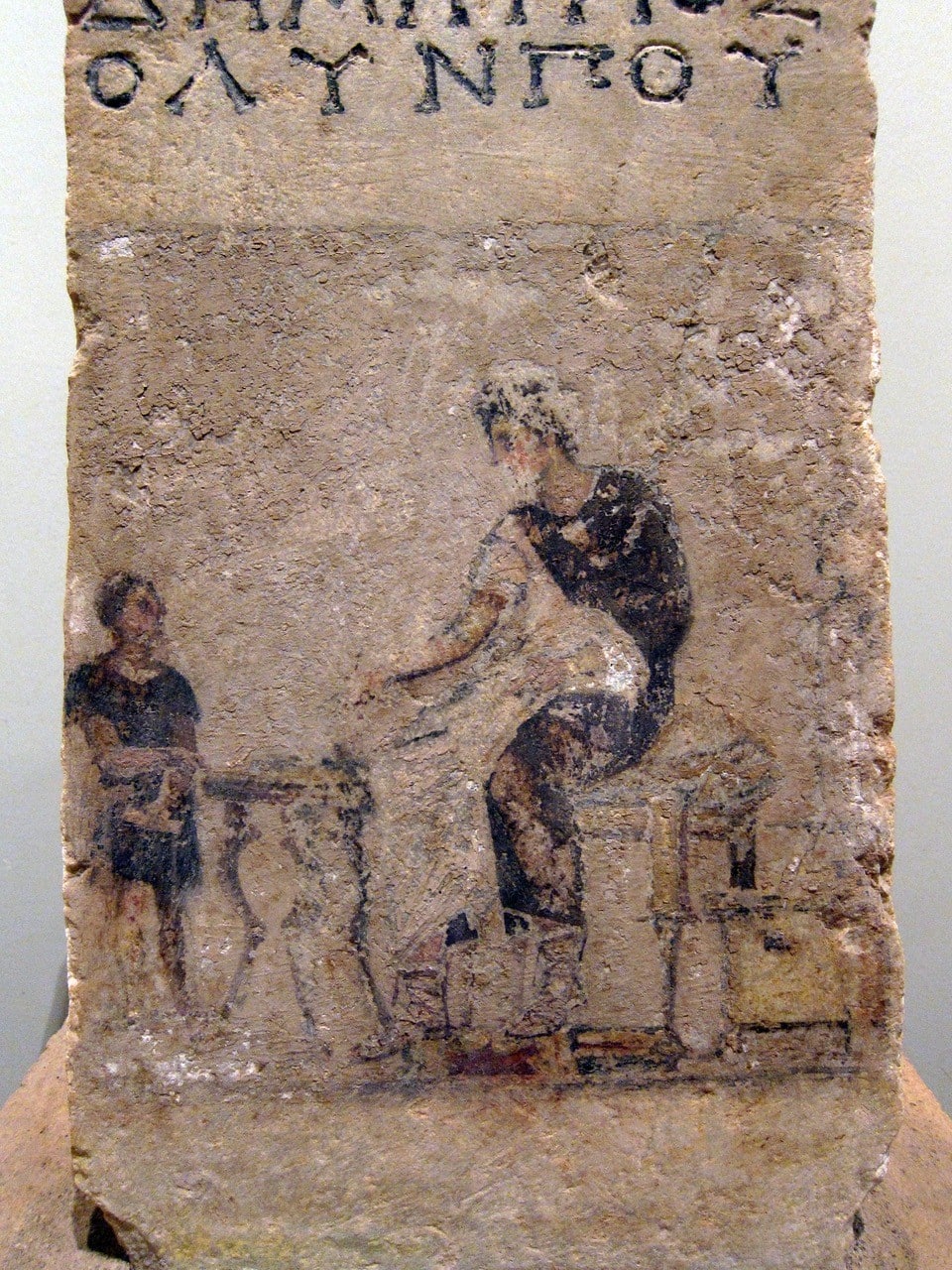 Image of two men painted on stone