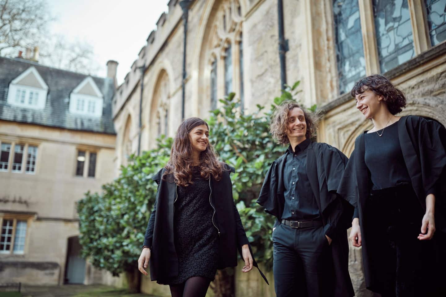 Three students in black gowns in Lincoln College