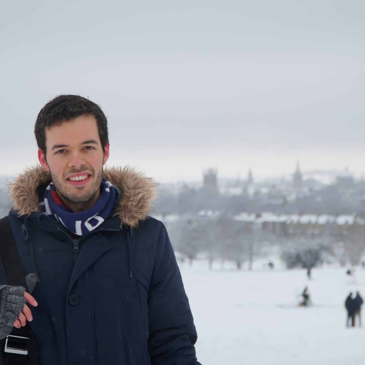 Photograph of Daniel Radford Smith, a young man in a blue coat, in front of a snowy background