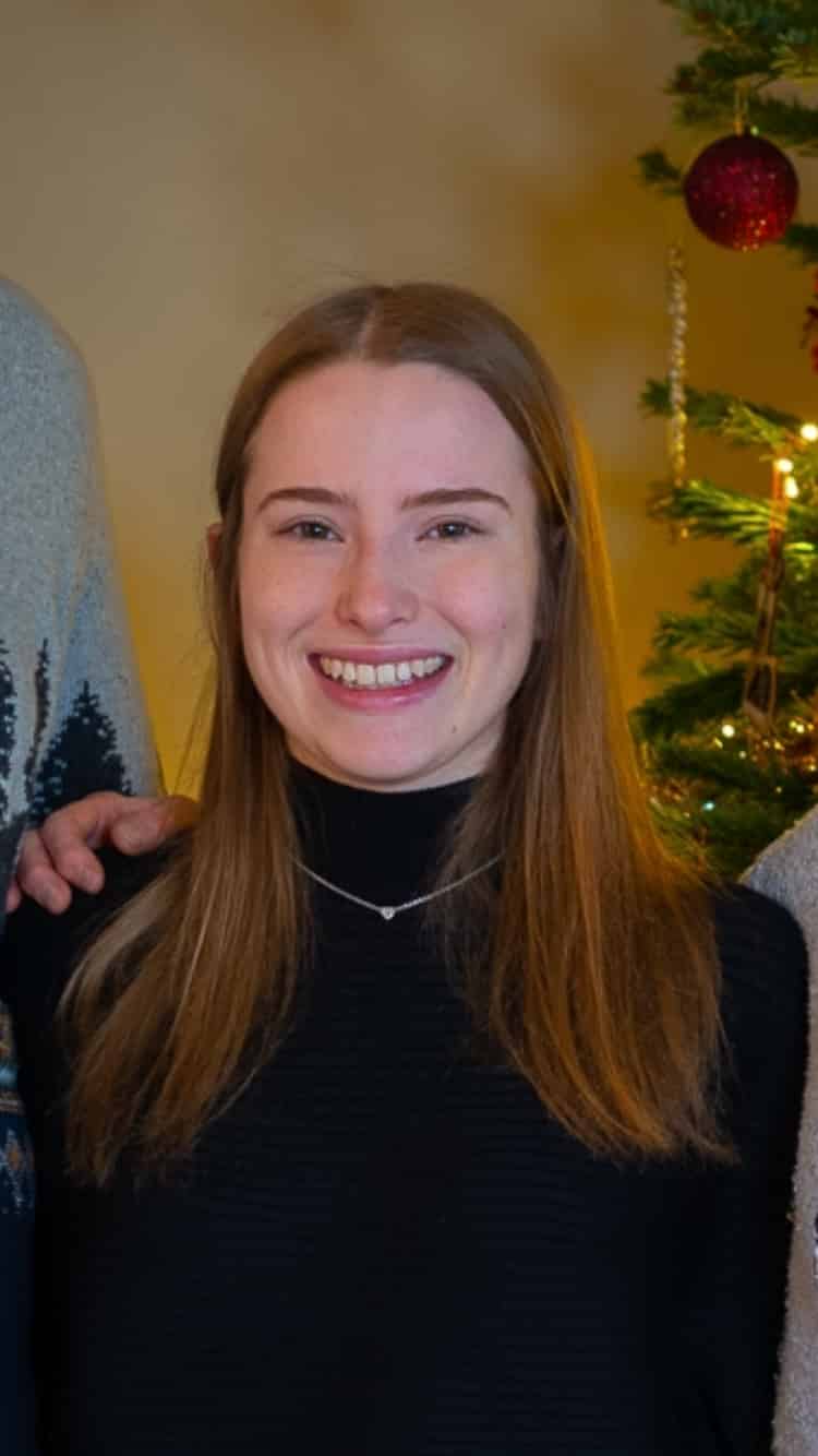 Headshot of Elizabeth Ealing, a young woman in black jumper and necklace