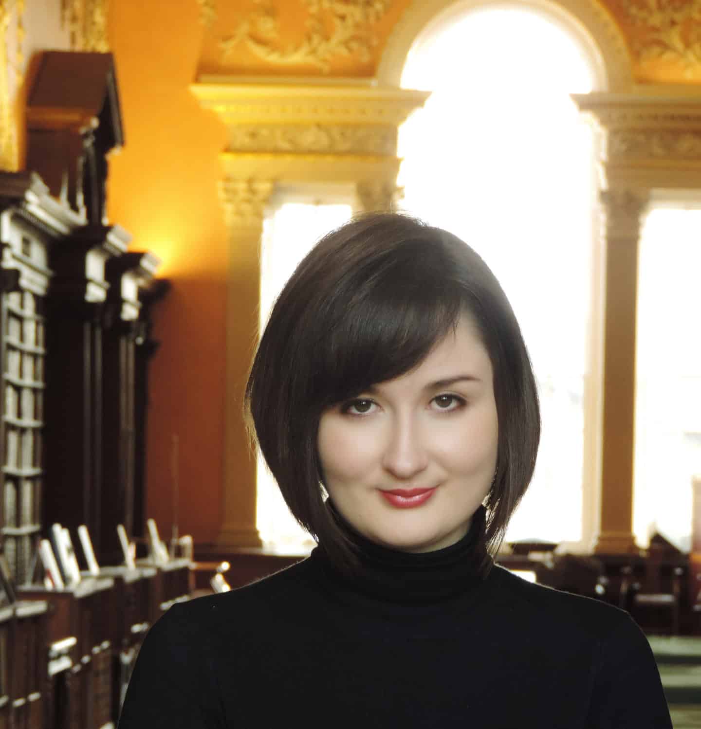 Headshot of Dr Gabrielle Watson, a woman in a black sweater