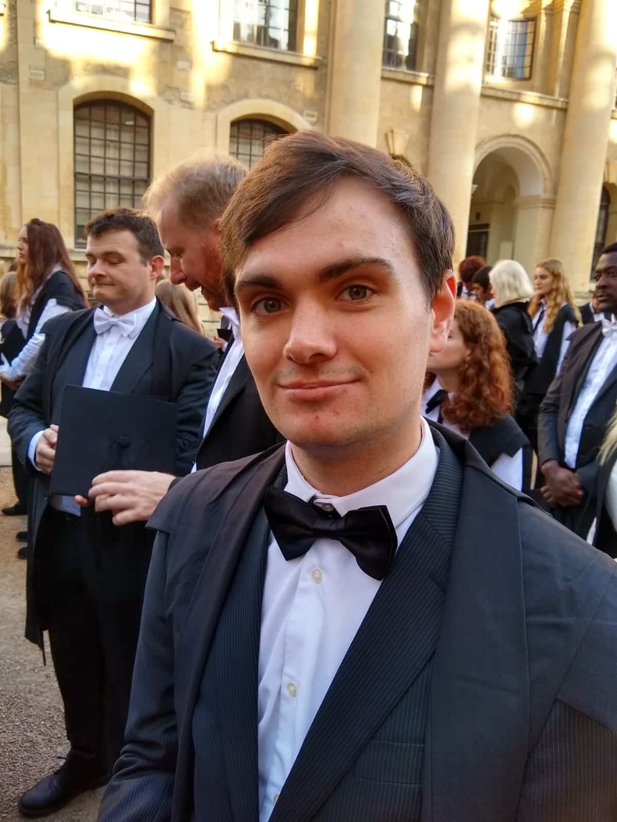 Photograph of Henry Brown, a young man in black tie, in a group of other students