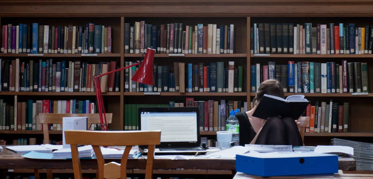 A student in the Lincoln College Library with her face in a book