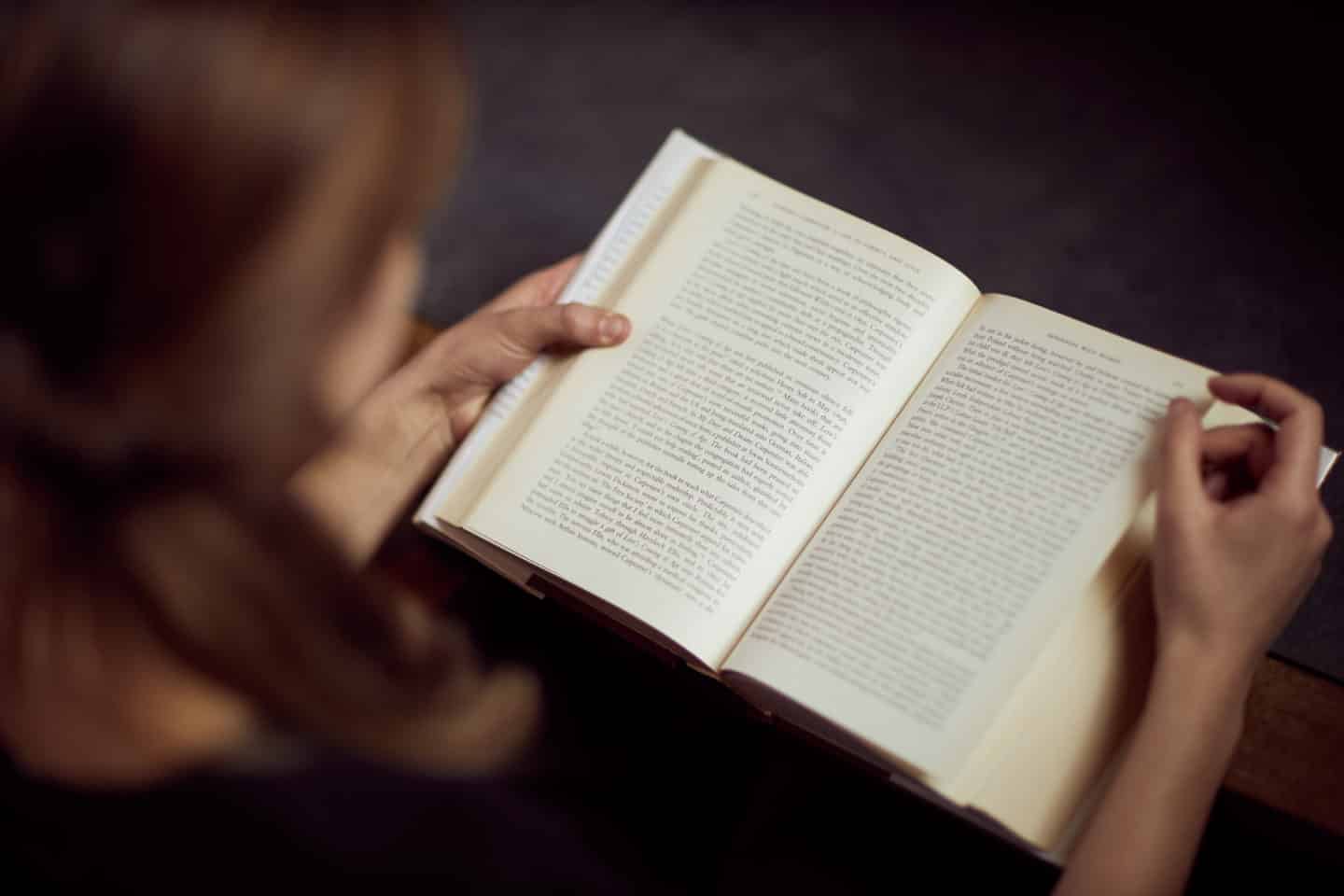 Lincoln student reading a book in the Library