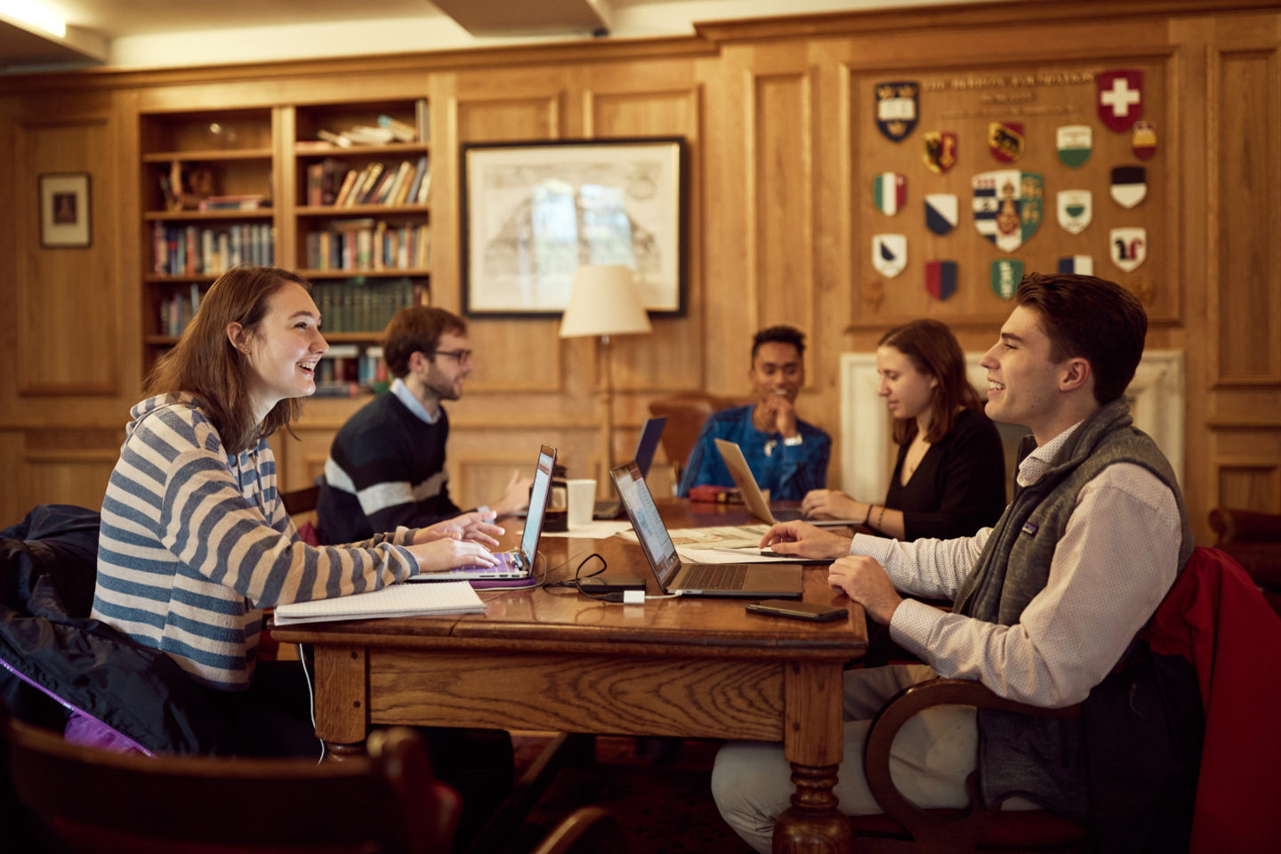 Students sitting around a table with open laptops in the Lincoln College MCR