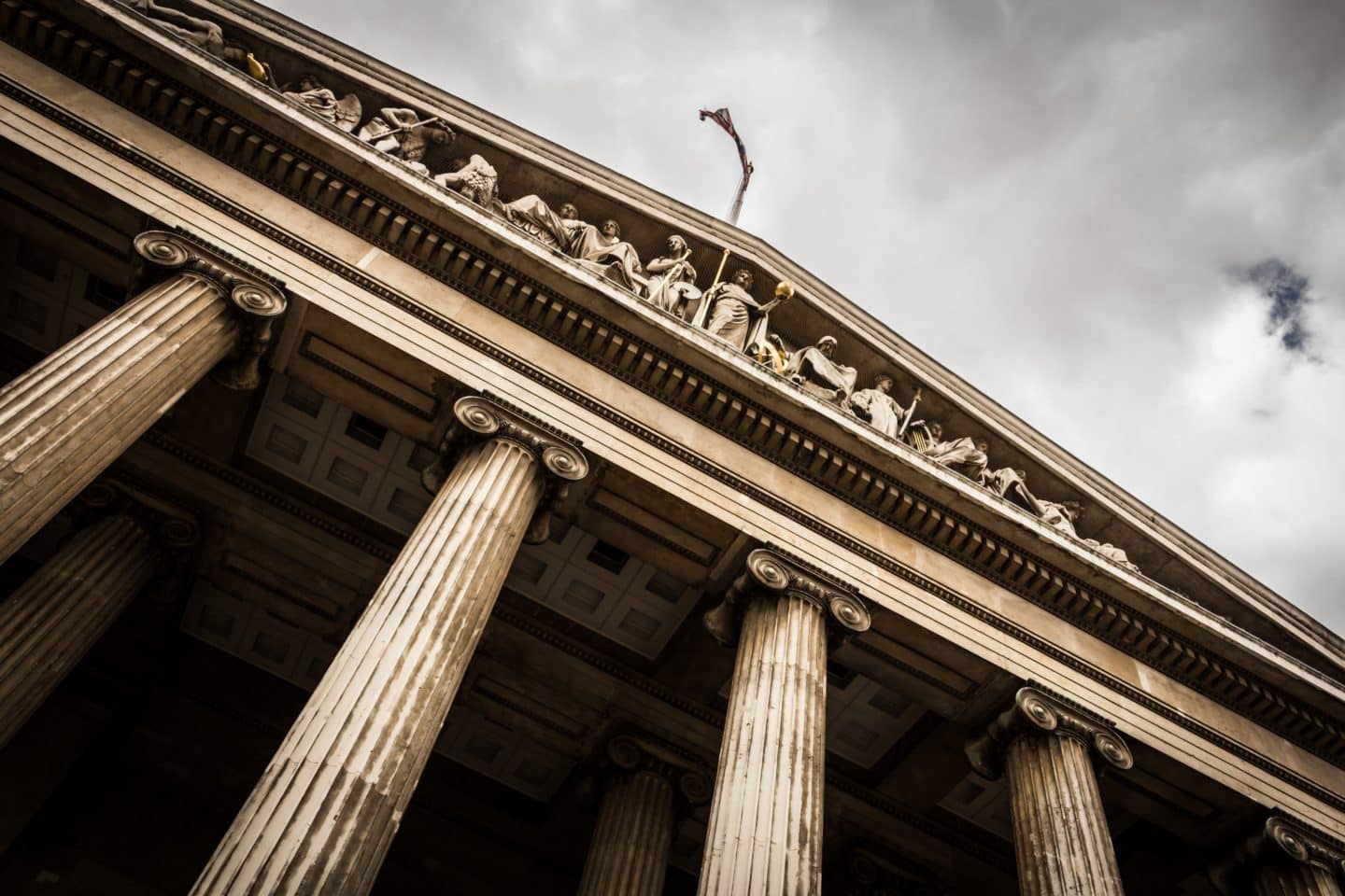 View of the top of a courthouse with its statues from below