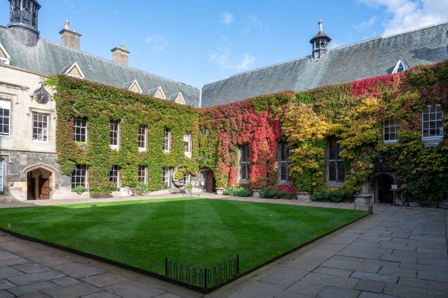 View of the Front Quad at Lincoln College, Oxford, under a clear blue autumn sky, with ivy showing shades of gold and red.