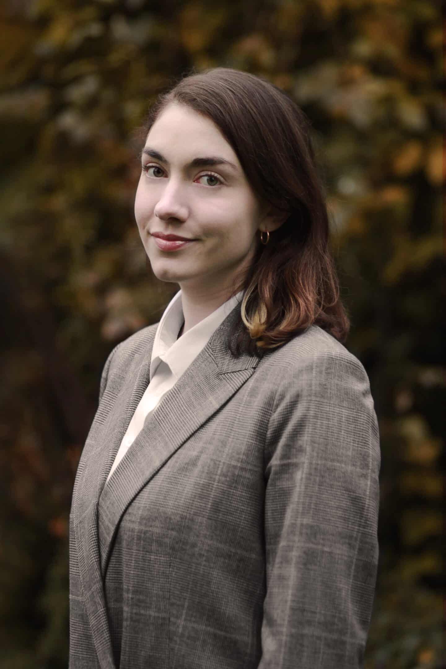 Headshot of Maryanne Saunders, a young woman in a grey suit jacket