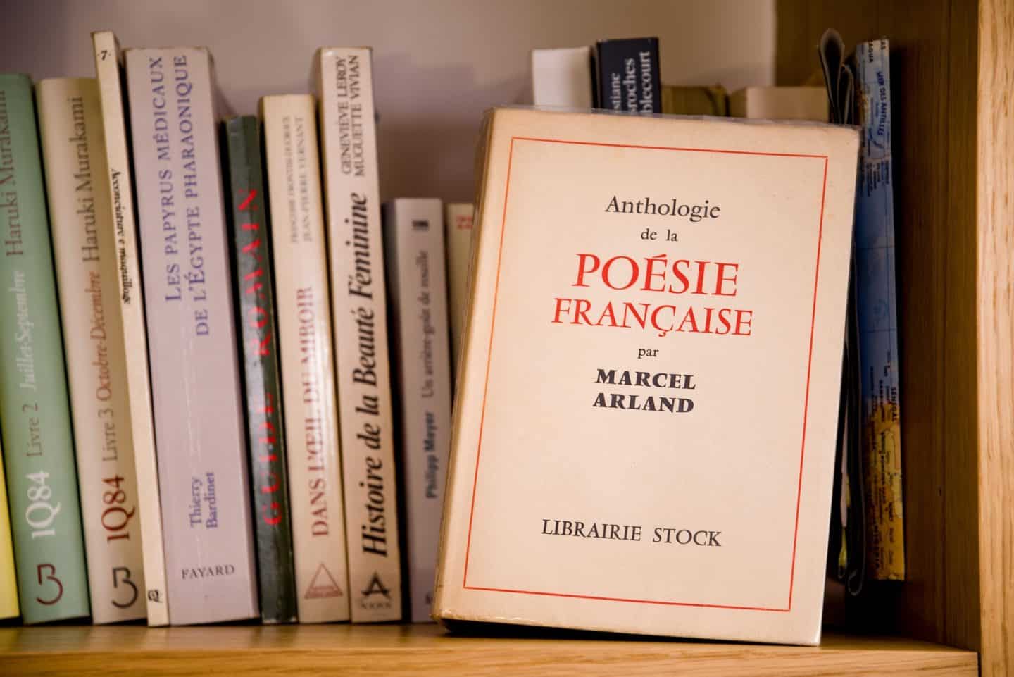 Marcel Arland's 'Anthologie de la Poesie Francaise' highlighted among other books on a shelf