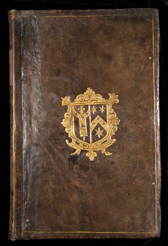 Closed cover of a book, with a golden crest