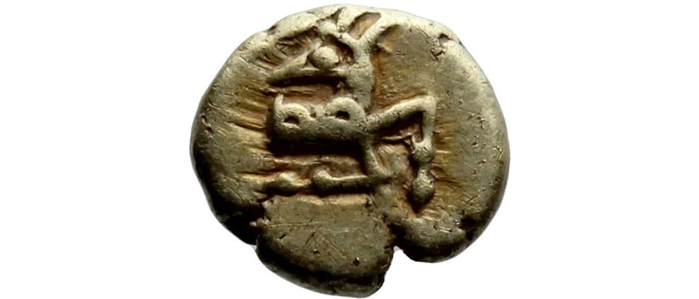 Ancient electrum coin showing a worn stamped design with abstract punch marks on one side.