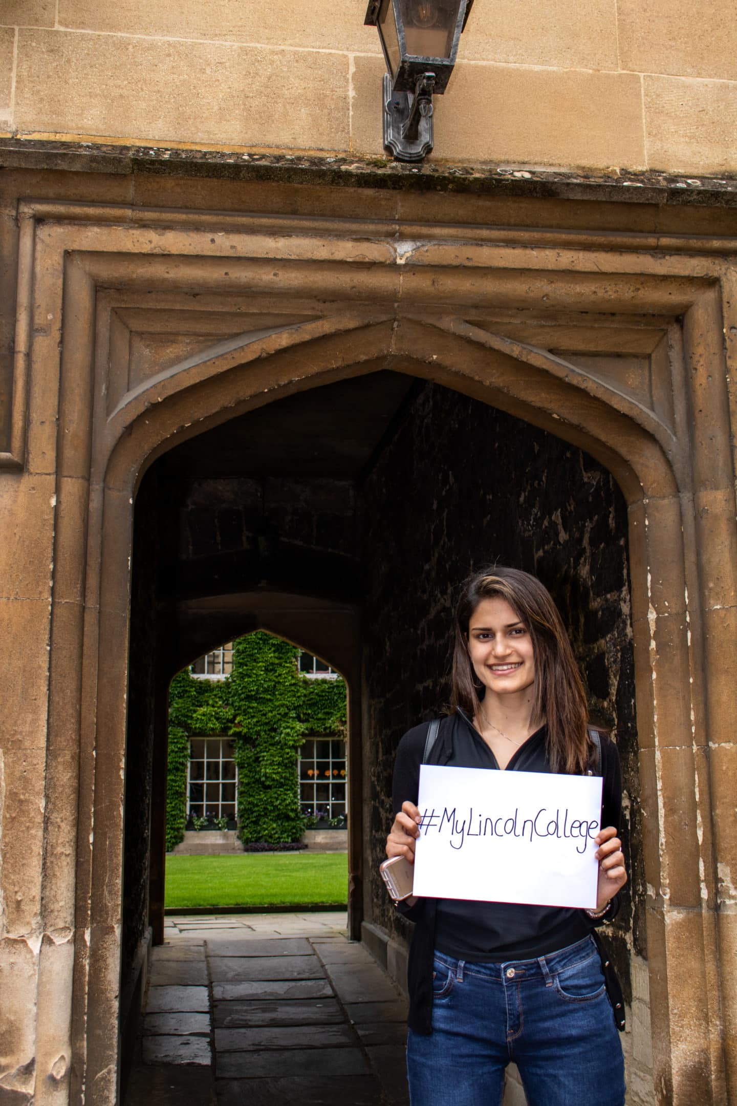 Current student holds sign reading hashtag My Lincoln College