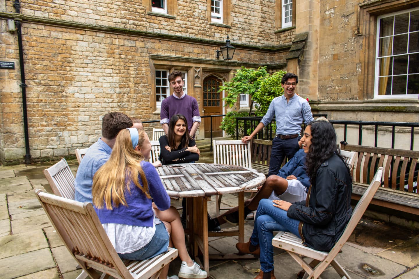 A group of students around a table in Lincoln College's Grove Quad